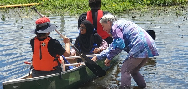 [Organizing the small child in the Mohawk canoe, 12:30:49]