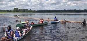 [Movie: Gretchen and Debbie in canoes, Dan helping a kayak across the barrier, 14:43:22]