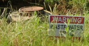 [Sign: Warning, Wastewater Spill --Google Streetview]