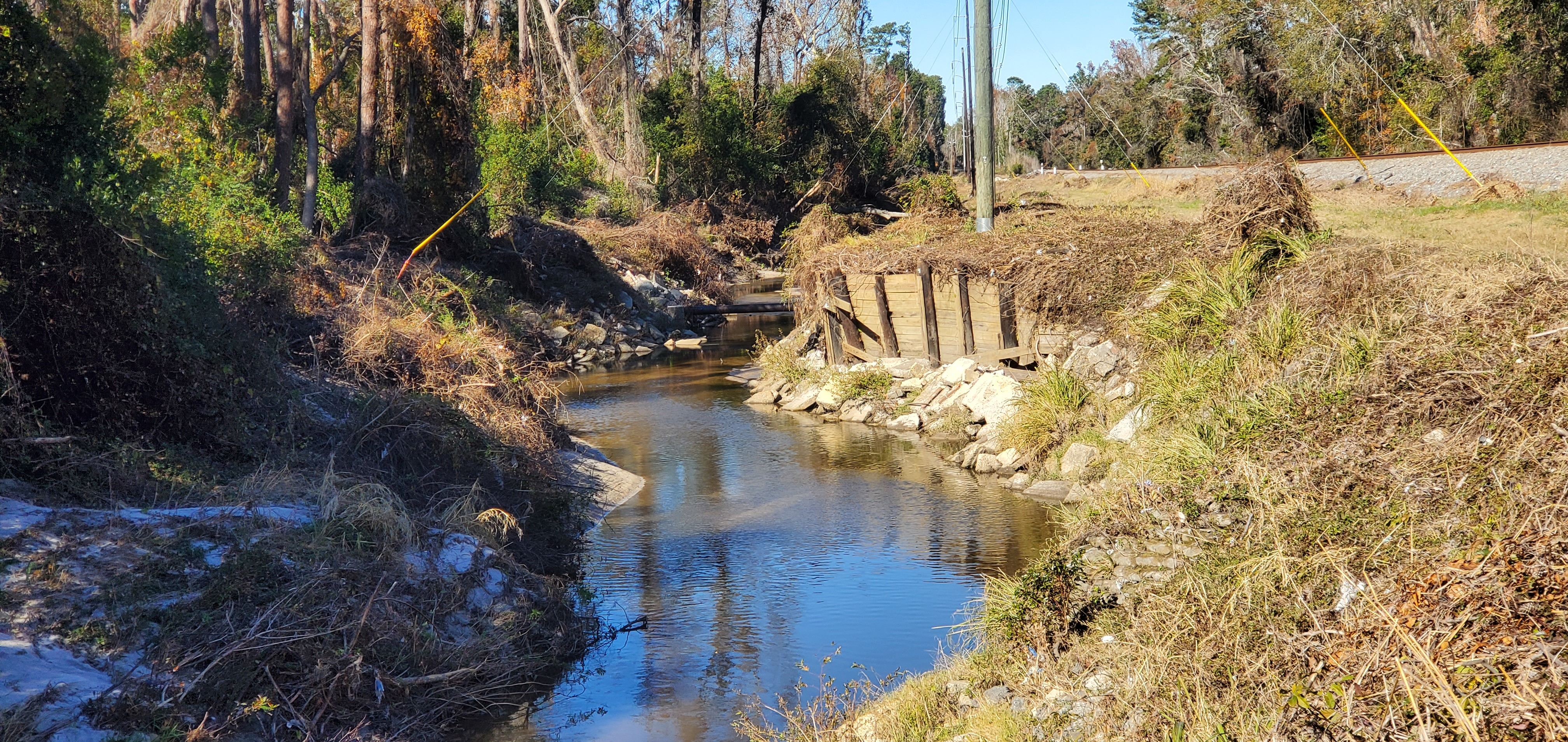 Bank shoring sagging under power pole, Sugar Creek 2024-12-12, 13:13:26, 30.8483673, -83.3135081