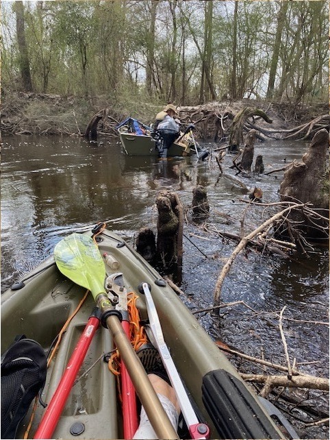 Trash, picker, clippers, and paddle --Tish Hall