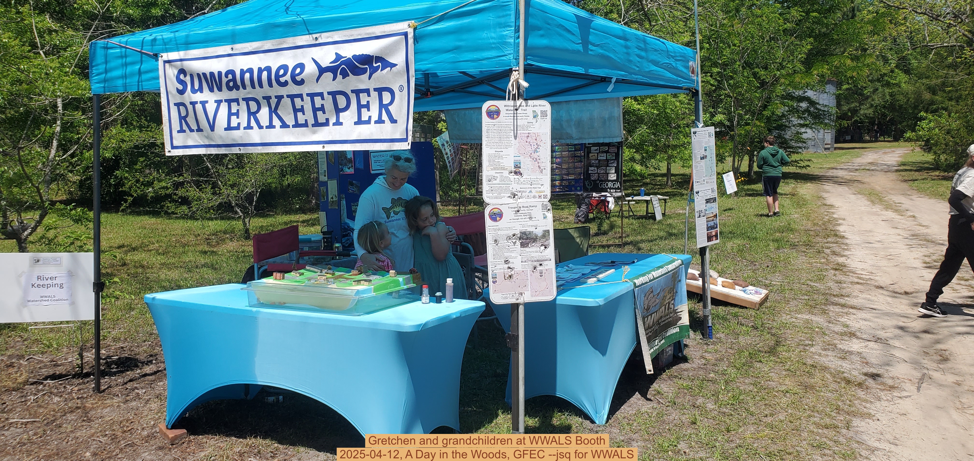 Gretchen and grandchildren at WWALS Booth, 2025-04-12, A Day in the Woods, GFEC --jsq for WWALS