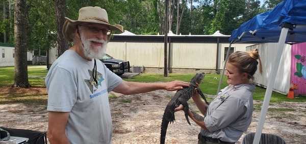 [jsq petting the alligator with Jolie Hoyle of OSP --Shirley Kokidko]