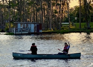 [Janet Martin waving from her canoe --Kimberly Godden Tanner]