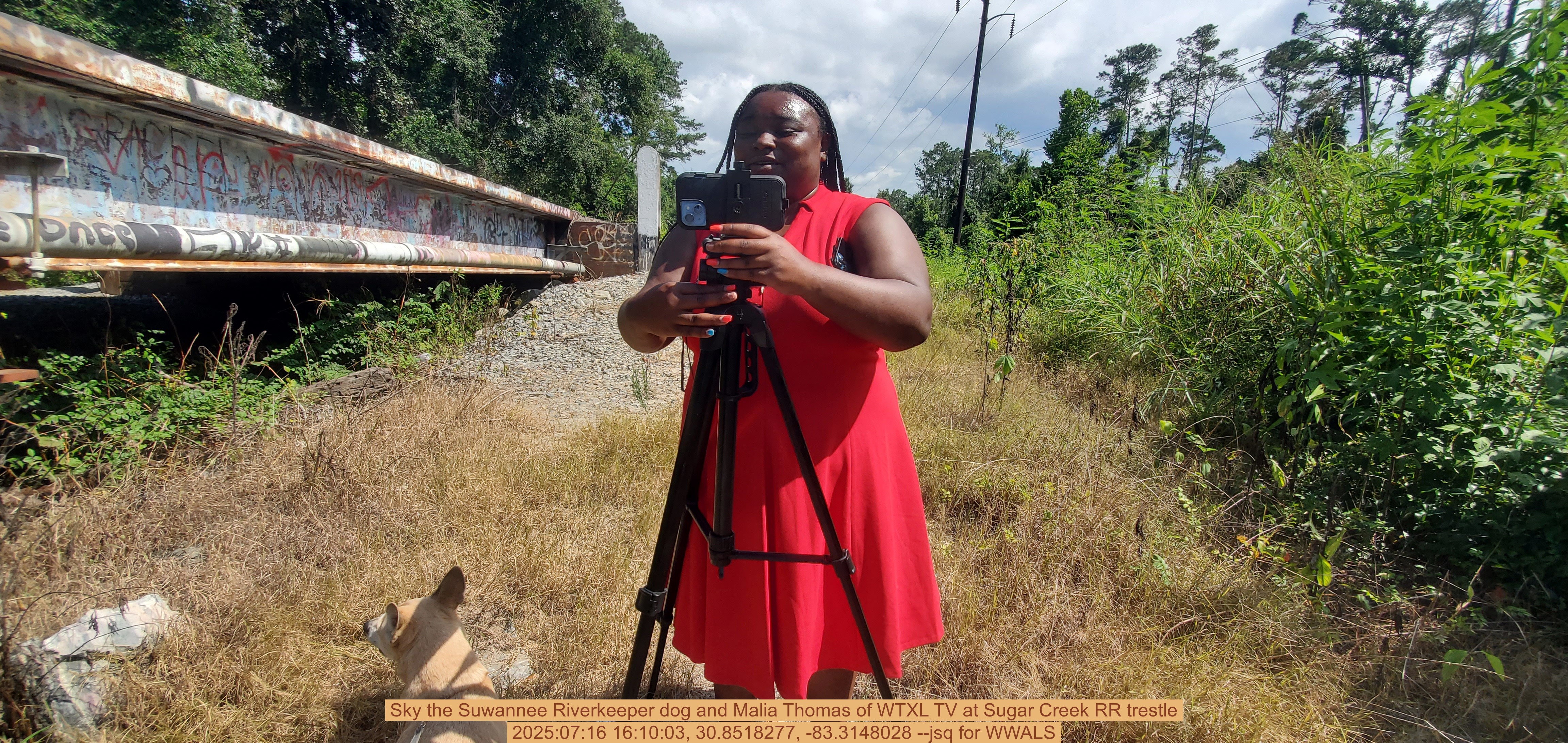 Sky the Suwannee Riverkeeper dog and Malia Thomas of WTXL TV at Sugar Creek RR trestle, 2025:07:16 16:10:03, 30.8518277, -83.3148028 --jsq for WWALS