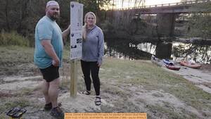 [Movie: Darrell & Melissa with the signs he planted at Nankin Boat Ramp, 2025:11:22 17:52:25, 30.6748479, -83.3940384 (7.8M) --jsq for WWALS]