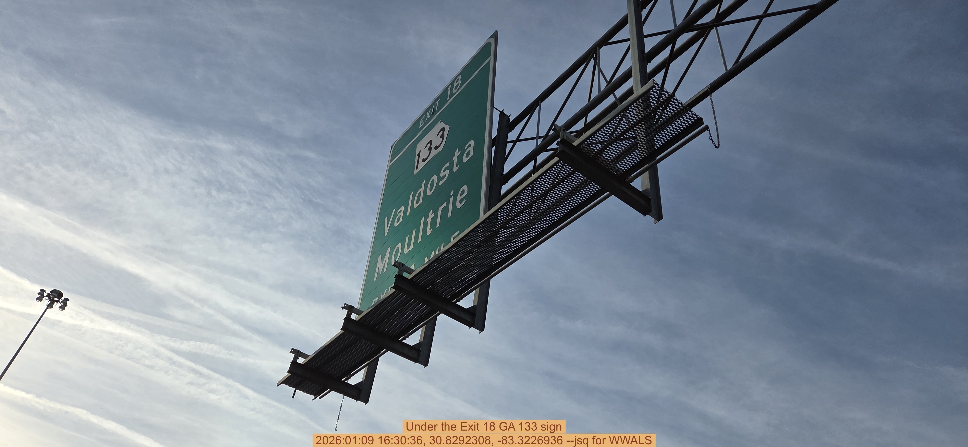 Under the Exit 18 GA 133 sign, 2026:01:09 16:30:36, 30.8292308, -83.3226936 --jsq for WWALS