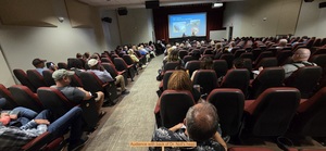 [Audience with back of Dr. Noll's head]