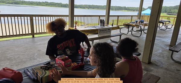 Child games, Suwannee Riverkeeper table, tent, boats, lake, 2026:06:20 12:24:48, 31.1621575, -83.5482575 --jsq for WWALS