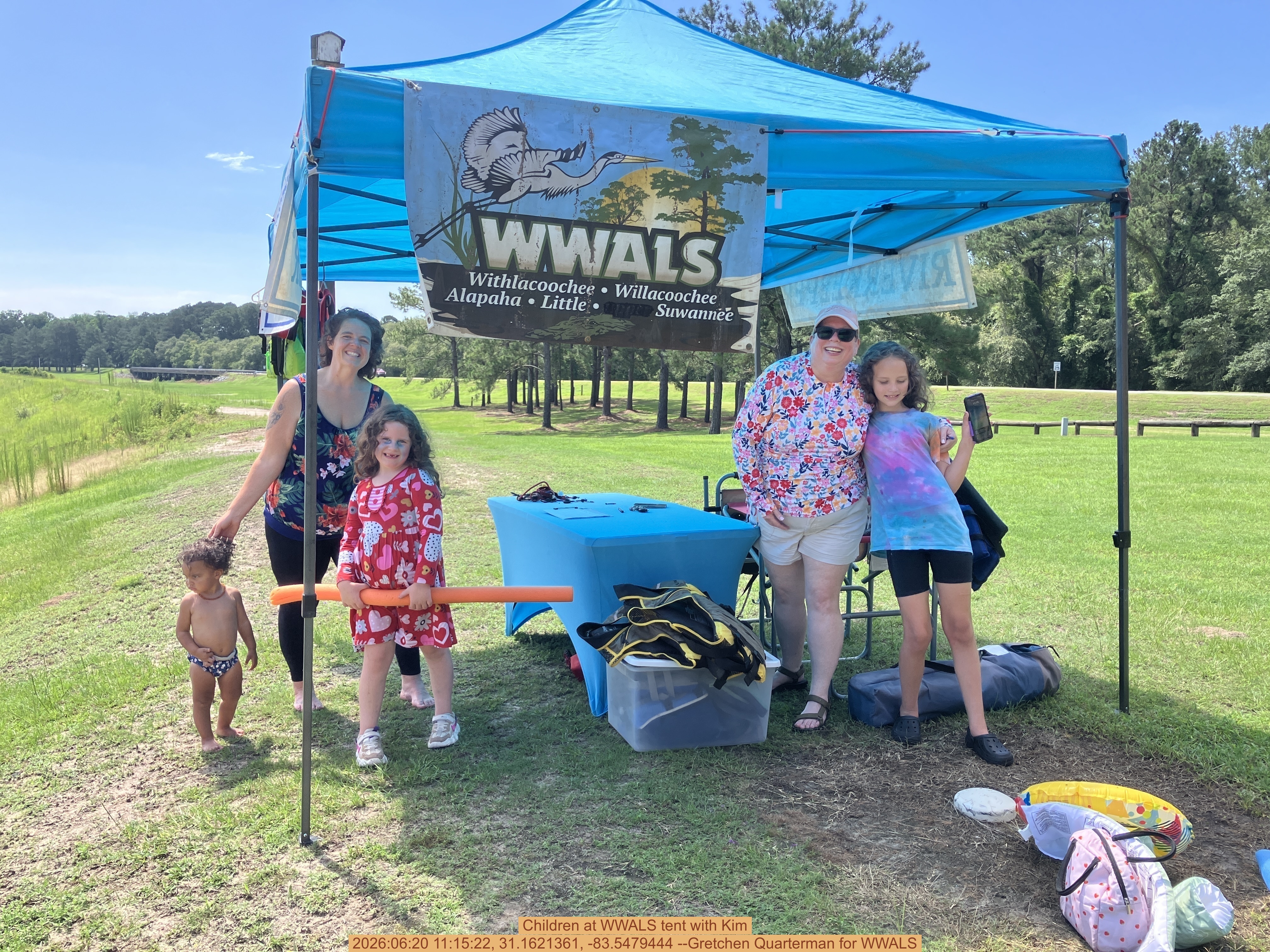 Children at WWALS tent with Kim, 2026:06:20 11:15:22, 31.1621361, -83.5479444 --Gretchen Quarterman for WWALS