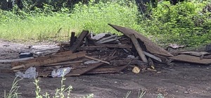 [Construction debris dumped under Hagan Bridge, 2026:06:26 11:47:57, 31.0137387, -83.3012887]