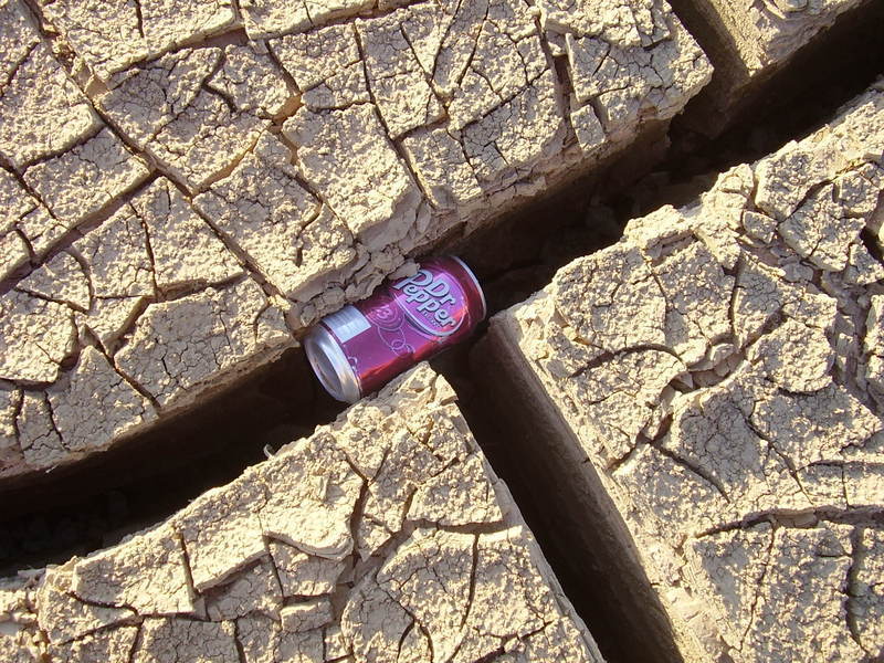 Dr. Pepper can in cracked dirt