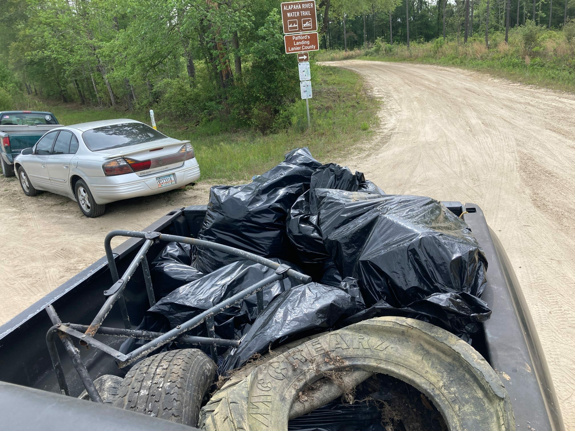 Out we go. 10 bags. Each 25-30 pounds plus three tires. The Lanier County dump site refused to take the tires without us paying. I'm not paying to dispose of someone else's tires.