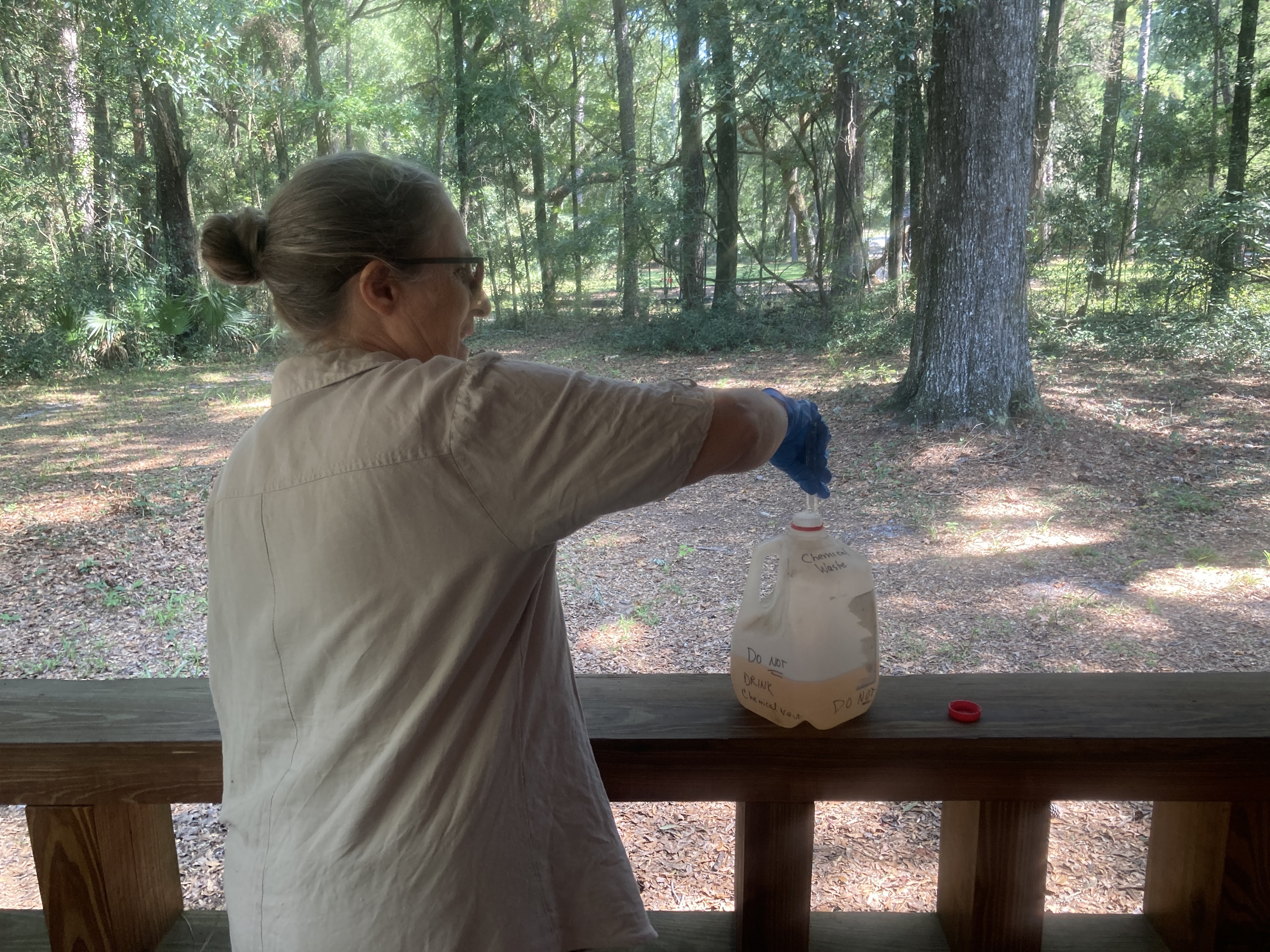 Joanne Tremblay with the chemical waste jug