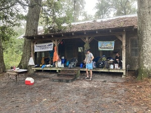 [Standing under the porch roof --Gretchen Quarterman, 2024:11:11 08:04:47, 30.8560861, -82.2669444]