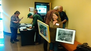 Deanna Mericle with Julie Bowland painting and Bryan Garris photograph she bought